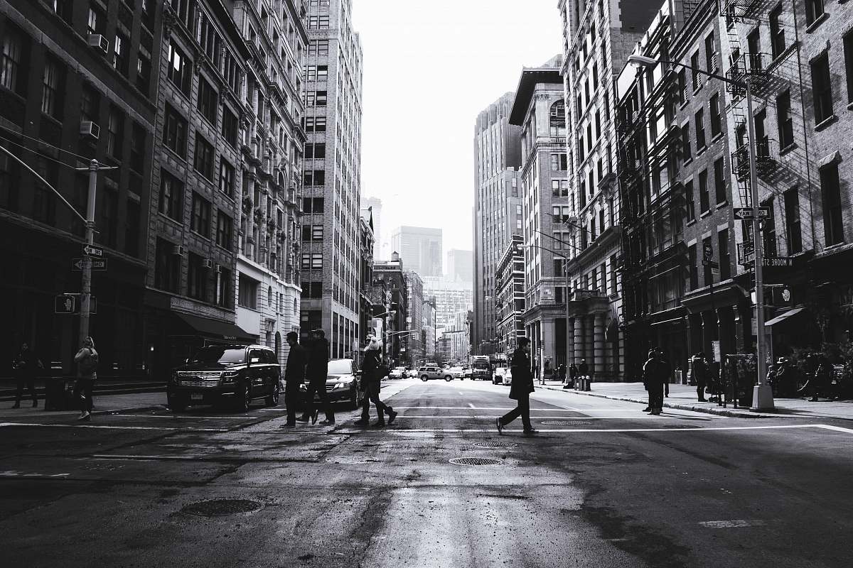 road grayscale photography of people crossing the street manhattan